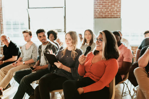 istock Cheerful woman speaking on a microphone in a workshop 2157540714
