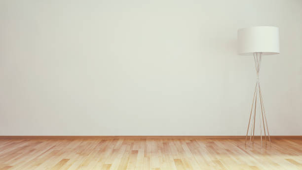 Empty domestic room with wood floors, white moulding  and brown wall.