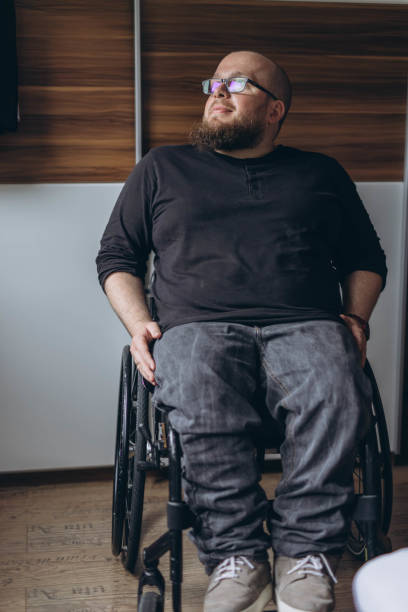 istock A young man sitting in a chair looking out the window 2157541313