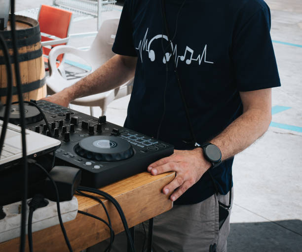 istock DJ Adjusting Sound Mixer at Outdoor Event 2157542004