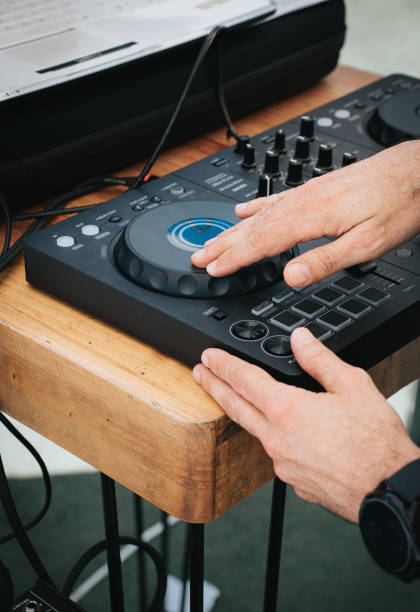 istock Close-Up of DJ's Hands Operating Sound Mixer 2157542024