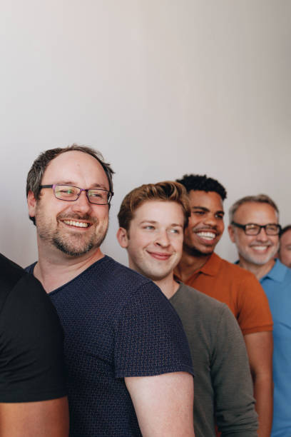 istock Cheerful diverse men standing in a row 2157542079