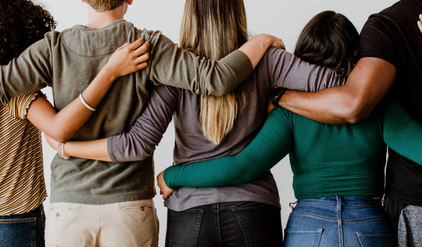 istock Rearview of diverse people hugging each other 2157542250