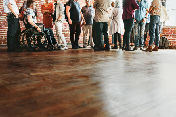 istock Group of diverse people standing in front of a brick wall 2157543223
