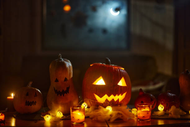 Jack O' Lantern at night! Close up of illuminated carved pumpkin on Halloween. halloween pumpkin decorations stock pictures, royalty-free photos & images