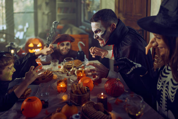 istock Carefree family having fun on Halloween at dining table. 2157543761
