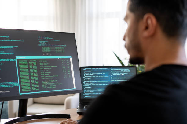 istock Young adult man trying to learn coding at home 2157544120