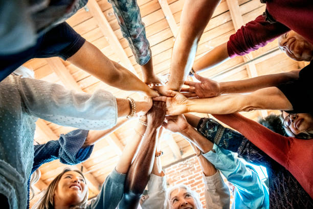 istock Group of diverse people stacking hands in the middle 2157544311