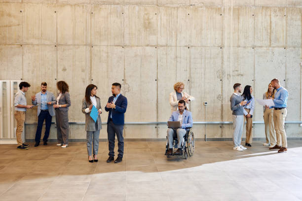 istock Multi-tasking business colleagues working in a hallway. 2157544459