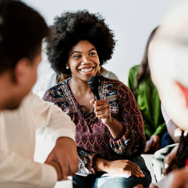 istock Cheerful woman speaking on a microphone in a workshop 2157544698