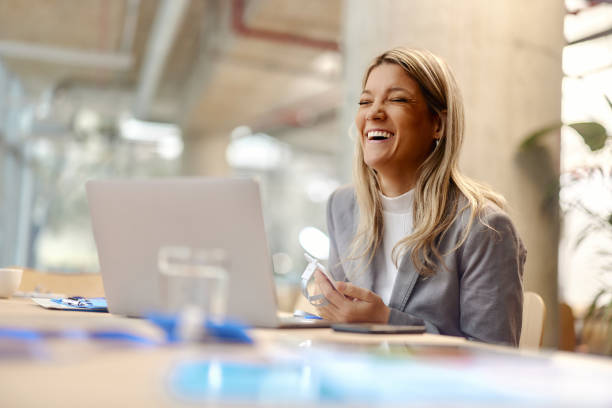 istock Cheerful businesswoman having fun while using laptop in the office. 2157544941