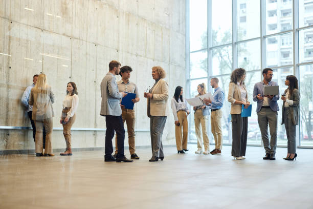 istock Large group of multi-tasking entrepreneurs in a hallway. 2157545677