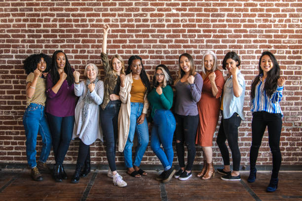 istock Powerful women standing together with clenched fists 2157546429