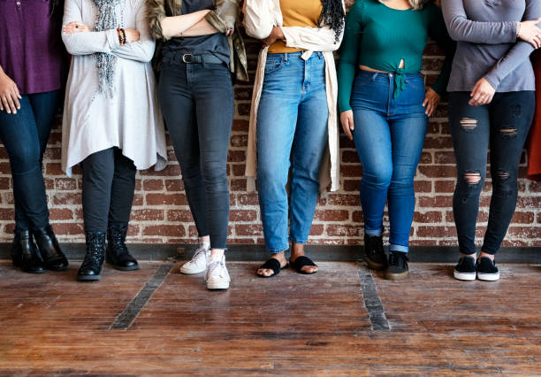 istock Women standing together by a brick wall 2157546435