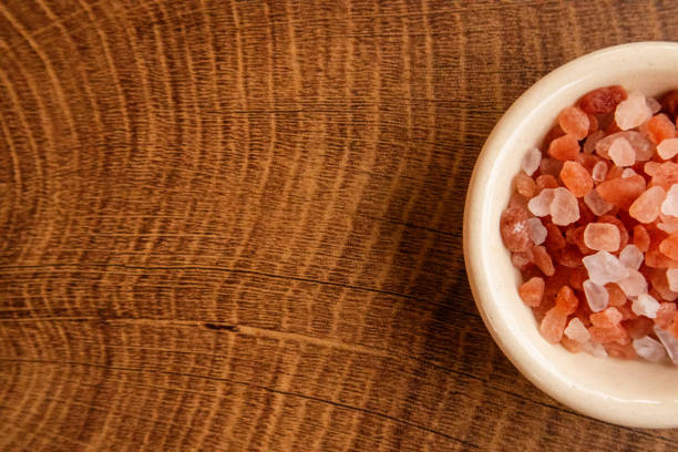 Himalayan pink and white crystal salt on bowl which is naturally derived which has more benefits and minerals than any other salt.