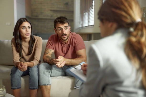 istock Young couple having a counseling session with therapist at home. 2157546457