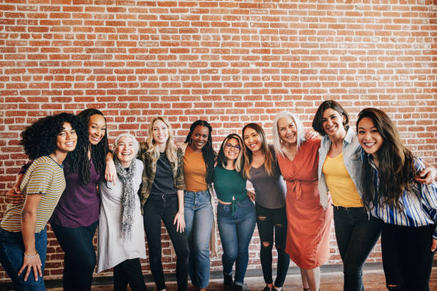 istock Diverse women standing together by a brick wall 2157546478