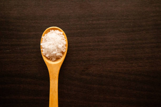 Mineral desert salt on spoon from nature collected during the winter
