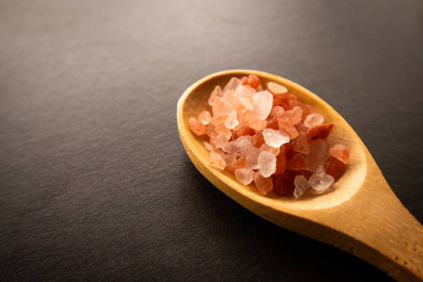 istock Himalayan pink and white crystal salt on spoon which is naturally derived which has more benefits and minerals than any other salt. 2157546575