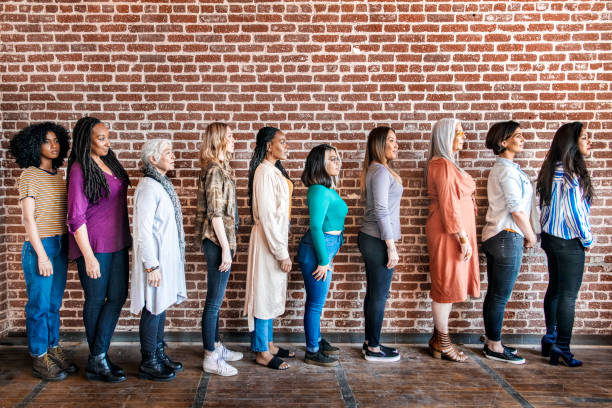 istock Woman standing by a brick wall 2157546594