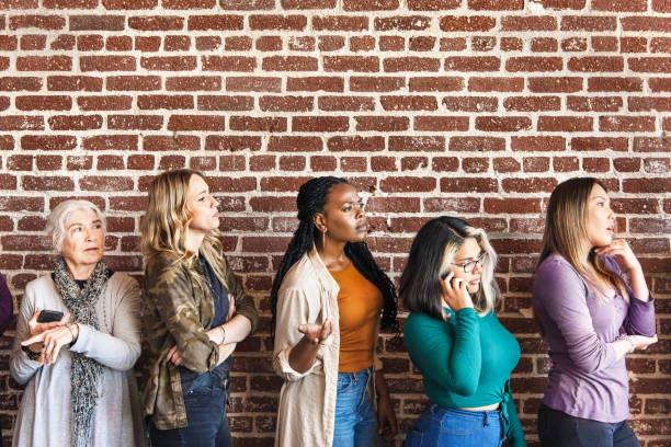 istock Woman standing by a brick wall 2157546597