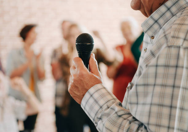 istock Elderly man speaking on a microphone in a seminar 2157546638
