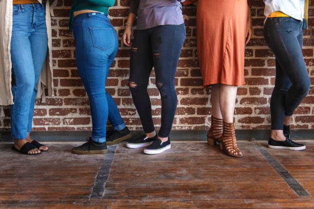 istock Women standing together by a brick wall 2157546665