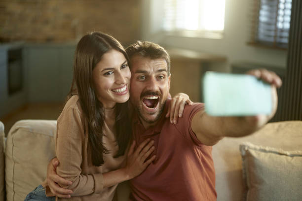 istock Happy couple taking a selfie with cell phone at home. 2157546673