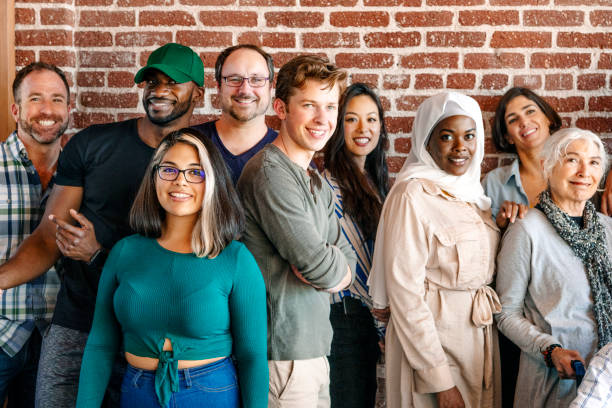 istock Group of diverse people standing in front of a brick wall 2157546805