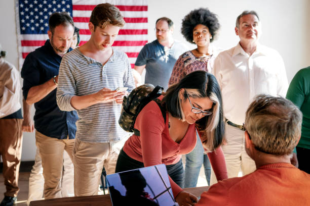 istock Diverse people queuing at a polling place 2157547061