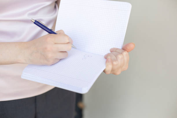 istock open blank notepad in female hands, calm colors, soft focus 2157548893