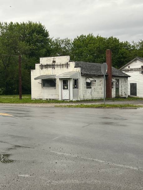 istock White abandoned building on cloudy day with trees as background. 2157549734