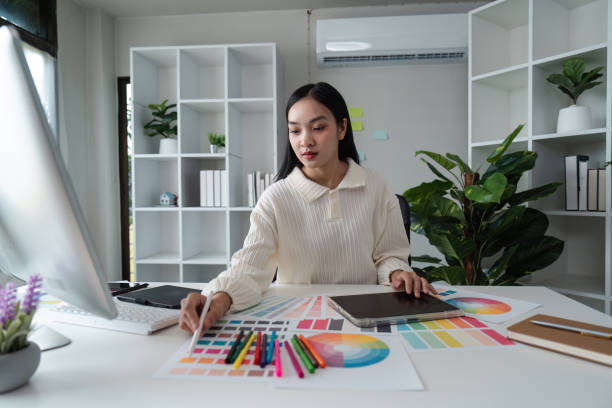 istock designer graphic at work drawing sketches a new project on graphic tablet and color palette sitting at desk with computer at studio or office 2157550188