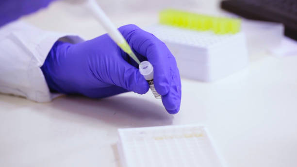 istock Scientist pours liquid into a syringe 2157551708