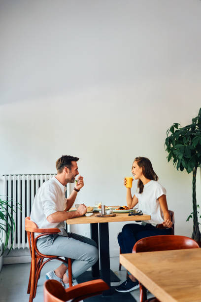 istock Smiling couple eating breakfast together at bistro cafe 2157551742