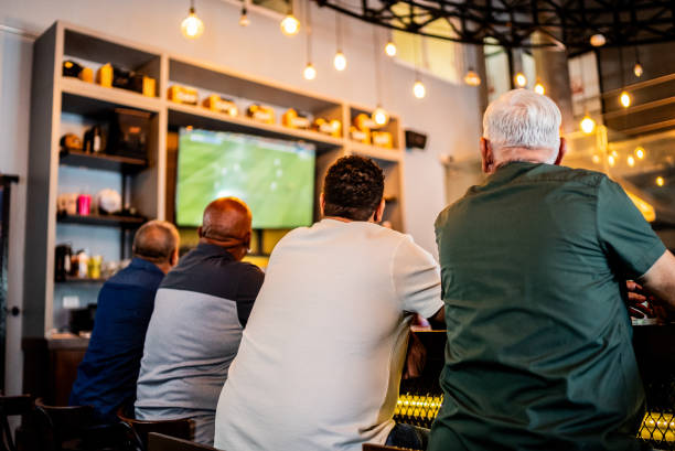 istock Senior men watching soccer match on the bar 2157552059