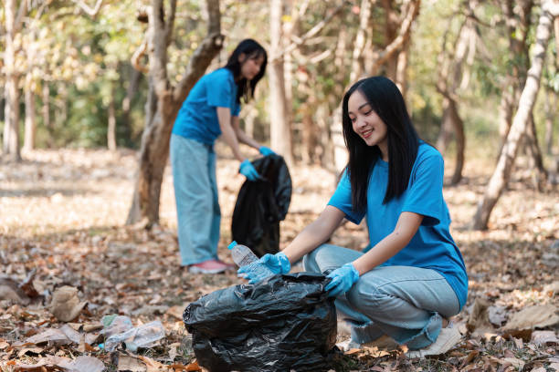 istock Volunteers Collecting Trash in Forest, Eco-Friendly Community Service, Environmental Conservation, Young People Cleaning Nature, Sustainable Living, Outdoor Cleanup, Teamwork in Nature, Green 2157552142