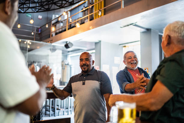 istock Senior men greeting friends at bar 2157552146