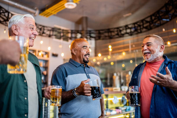 istock Senior friends talking and drinking beer on the bar 2157552160