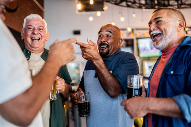 istock Senior friends talking and drinking beer on the bar 2157552197