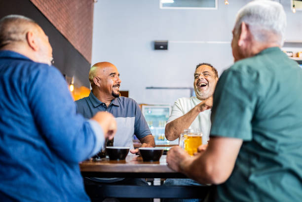 istock Senior friends talking and drinking beer on the bar 2157552221