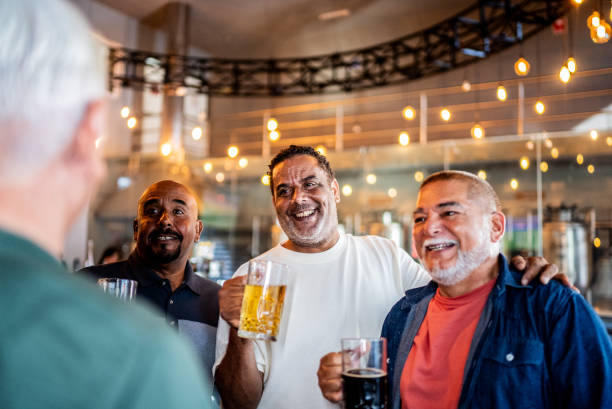 istock Senior friends talking and drinking beer on the bar 2157552242