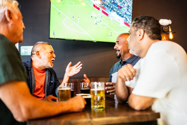 istock Senior friends talking and drinking beer on the bar 2157552328
