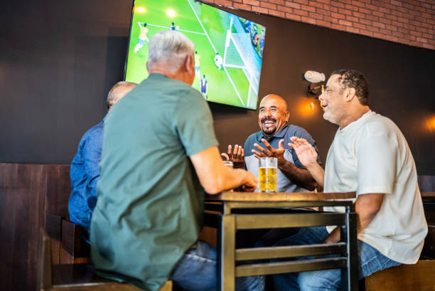 istock Senior friends talking and drinking beer on the bar 2157552330