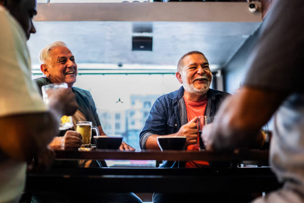 istock Senior friends talking and drinking beer on the bar 2157552345