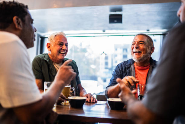 istock Senior friends talking and drinking beer on the bar 2157552348
