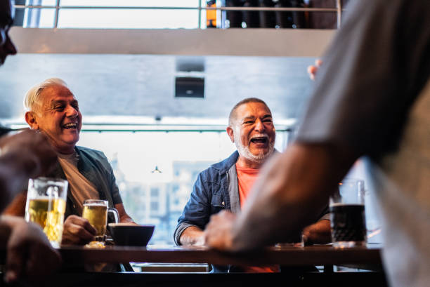 istock Senior friends talking and drinking beer on the bar 2157552350