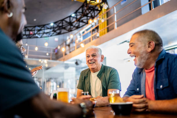 istock Senior friends talking and drinking beer on the bar 2157552363