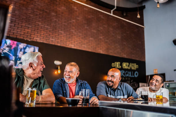 istock Senior friends talking and drinking beer on the bar 2157552477