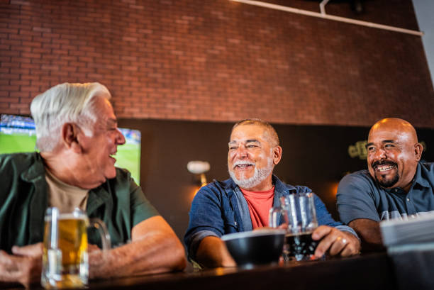 istock Senior friends talking and drinking beer on the bar 2157552485